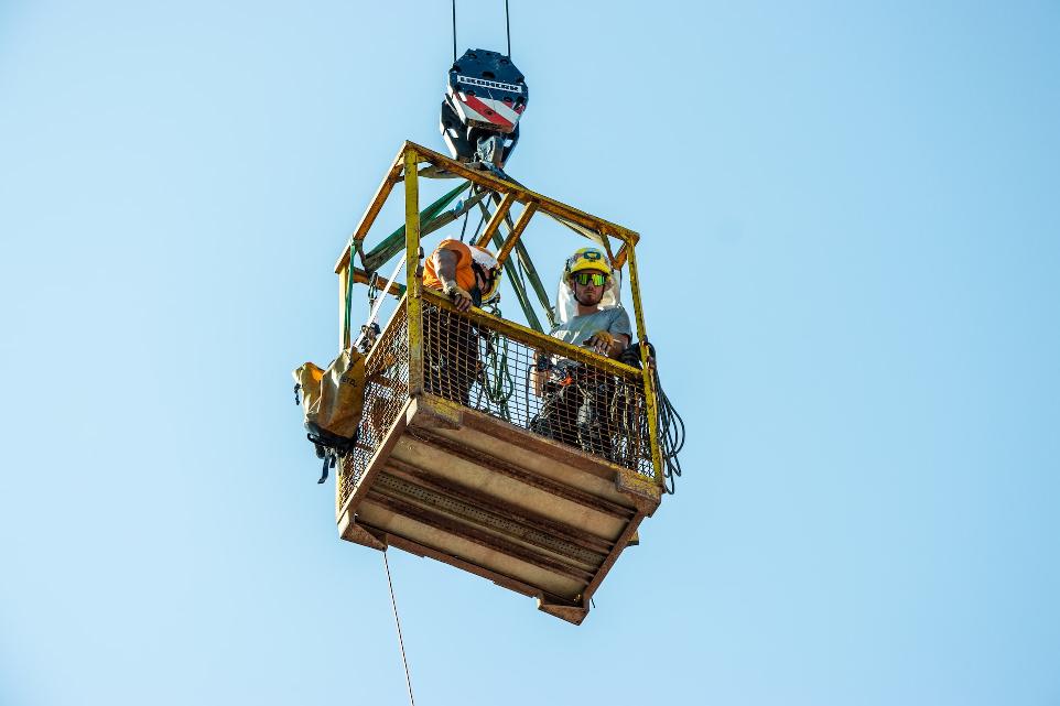 a group of people standing on top of a wooden platform